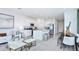 Open-concept living area with white kitchen, island seating, and modern decor at 7811 Waterscape Dr, Groveland, FL 34736