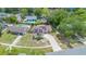 Aerial view of a home with solar panels, a backyard with a pool, and surrounding trees at 811 Osceola Trl, Casselberry, FL 32707