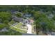 Expansive aerial view of a well-maintained home featuring solar panels and surrounded by lush greenery at 811 Osceola Trl, Casselberry, FL 32707