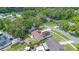 Aerial view of a single-Gathering home with backyard shed and solar panels on roof nestled amongst verdant trees at 811 Osceola Trl, Casselberry, FL 32707