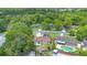Aerial view of a single-Gathering home with backyard pool and solar panels on roof in a lush, green neighborhood at 811 Osceola Trl, Casselberry, FL 32707