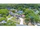 Expansive aerial view of a single-Gathering home with solar panels, a curved driveway, and lush surrounding greenery at 811 Osceola Trl, Casselberry, FL 32707