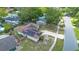 Aerial view of a home with solar panels, driveway, backyard, and surrounding trees in a residential neighborhood at 811 Osceola Trl, Casselberry, FL 32707
