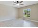Bedroom with tile floors, a ceiling fan, and a window offering natural light at 811 Osceola Trl, Casselberry, FL 32707