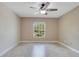 Bedroom featuring tile floors, a ceiling fan, and a bright window at 811 Osceola Trl, Casselberry, FL 32707