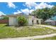 Cozy single-story home featuring solar panels, a well-manicured lawn, and a quaint front facade at 811 Osceola Trl, Casselberry, FL 32707