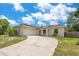 Charming single-story home boasting a long, private driveway and manicured landscaping under a bright sky at 811 Osceola Trl, Casselberry, FL 32707