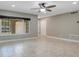 Neutral-toned living space with large windows, providing ample light, complemented by tile flooring at 811 Osceola Trl, Casselberry, FL 32707