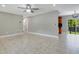 Neutral living room flows into dining area, highlighted by a modern chandelier and glass sliding doors at 811 Osceola Trl, Casselberry, FL 32707