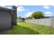 Large backyard showcasing a well-maintained lawn, a sturdy privacy fence, and mature landscaping at 8111 Lianna Dr, Orlando, FL 32822