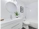 Bright bathroom featuring a modern vanity, a round mirror, and a bathtub with a shower at 8111 Lianna Dr, Orlando, FL 32822