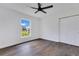Well-lit bedroom includes wood-look flooring, a ceiling fan, and a closet for added storage at 8111 Lianna Dr, Orlando, FL 32822