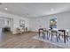 Open dining room boasts contemporary furnishings, natural lighting, and seamless transition at 8111 Lianna Dr, Orlando, FL 32822