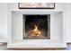 Modern fireplace with a clean white surround, showcasing a warm fire burning inside at 8111 Lianna Dr, Orlando, FL 32822