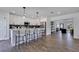 Modern kitchen features white cabinets, sleek stainless steel appliances and bar seating at 8111 Lianna Dr, Orlando, FL 32822