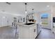 Kitchen island featuring black hardware and view of dining area with fireplace at 8111 Lianna Dr, Orlando, FL 32822