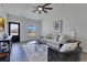 Bright living room features modern decor, a ceiling fan, and a view of the neighborhood at 8111 Lianna Dr, Orlando, FL 32822