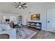 Open living room with fireplace, vaulted ceiling, ceiling fan, and wood-look flooring at 8111 Lianna Dr, Orlando, FL 32822