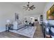 Bright living room with vaulted ceilings, ceiling fan and wood-look flooring at 8111 Lianna Dr, Orlando, FL 32822