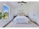 Bright main bedroom features a comfortable bed, neutral decor, and a view to the outdoors at 8111 Lianna Dr, Orlando, FL 32822