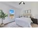 Cozy main bedroom with a comfortable bed, neutral decor, and ample natural light from the window at 8111 Lianna Dr, Orlando, FL 32822