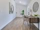 Stylish home office featuring modern desk, chair, art and light wood flooring, offering a functional workspace at 8111 Lianna Dr, Orlando, FL 32822