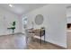 Bright office space with wood floors, a stylish desk, and a view to the home's beautiful outdoor landscape at 8111 Lianna Dr, Orlando, FL 32822