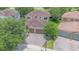 An aerial view of a house, landscaped yard, three-car garage, and clay tile roof at 8162 Prestbury Dr, Orlando, FL 32832