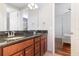 Bathroom with dual vanity, granite countertop, wood cabinets, and mirror at 8162 Prestbury Dr, Orlando, FL 32832