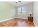 Cozy bedroom features a large window and hardwood floors, creating a comfortable and inviting space at 8162 Prestbury Dr, Orlando, FL 32832