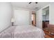Comfortable bedroom with a patterned bedspread and hardwood floors conveniently located near an en-suite bathroom at 8162 Prestbury Dr, Orlando, FL 32832