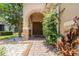 Inviting entryway with stone accents and a charming arched doorway at 8162 Prestbury Dr, Orlando, FL 32832