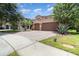 Stunning home with a three-car garage, brick driveway, and desert landscaping at 8162 Prestbury Dr, Orlando, FL 32832