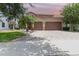 Beautiful two-story home featuring a three-car garage and brick-paved driveway at 8162 Prestbury Dr, Orlando, FL 32832