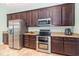 Modern kitchen boasts stainless steel appliances, granite countertops, and ample cabinet space for storage and functionality at 8162 Prestbury Dr, Orlando, FL 32832