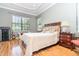 Serene main bedroom with neutral tones, hardwood floors and natural light creating a relaxing ambiance at 8162 Prestbury Dr, Orlando, FL 32832