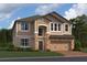 Charming two-story home with stone accents, a two-car garage, and a well-manicured lawn at 821 River Stone Trl, Sanford, FL 32771