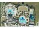 Aerial view showcasing community amenities, featuring pools, waterslides, recreational fields, and lush landscaping at 8955 Fluffy Lie Ct, Davenport, FL 33896