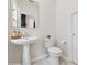 Clean, well-lit half-bathroom with a pedestal sink and modern fixtures at 8955 Fluffy Lie Ct, Davenport, FL 33896