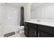 Bathroom featuring a shower-tub combo with dark vanity and gray accents at 8955 Fluffy Lie Ct, Davenport, FL 33896