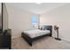 This bedroom has neutral colored carpet and a large window for ample natural light at 8955 Fluffy Lie Ct, Davenport, FL 33896