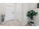 Bright foyer featuring tiled floors, closet space, and a decorative potted plant at 8955 Fluffy Lie Ct, Davenport, FL 33896