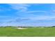 A sprawling green golf course under a blue sky at 8955 Fluffy Lie Ct, Davenport, FL 33896