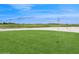 A golf course with a flag in the hole, set alongside a pond at 8955 Fluffy Lie Ct, Davenport, FL 33896