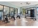 Modern gym featuring stationary bikes, strength training equipment, and mirrored walls for an effective workout at 8955 Fluffy Lie Ct, Davenport, FL 33896