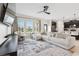 Bright and airy living room with an open floor plan, modern furnishings, and ample natural light at 8955 Fluffy Lie Ct, Davenport, FL 33896