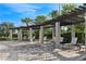 Covered lounge area offers relaxing seating in a resort-style pool area surrounded by lush landscaping at 8955 Fluffy Lie Ct, Davenport, FL 33896