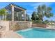 Scenic pool with a stone waterfall feature and lush tropical landscaping for a relaxing resort-style feel at 8955 Fluffy Lie Ct, Davenport, FL 33896
