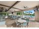 A spacious poolside dining area with ample seating and a convenient bar for a relaxing outdoor experience at 8955 Fluffy Lie Ct, Davenport, FL 33896