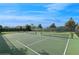 Well-maintained community tennis courts with lush landscaping and clear blue skies, perfect for recreational play at 8955 Fluffy Lie Ct, Davenport, FL 33896